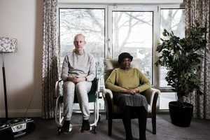 Man and woman sitting facing camera