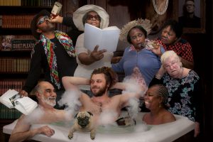 5 elders and 2 men in a tub with bubbles