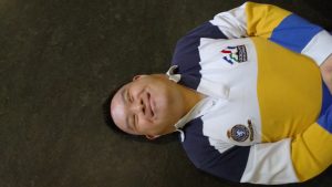 man laying on floor smiling
