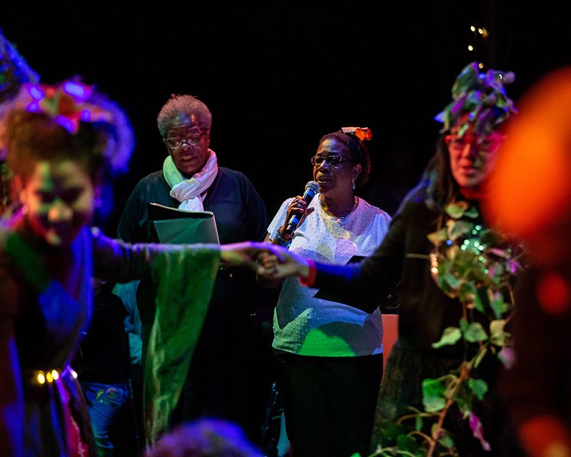 people on a stage talking on a microphone