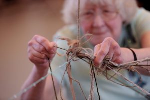 woman making sculpture with wool