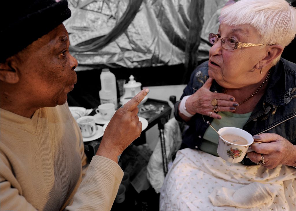 two older women talking over tea