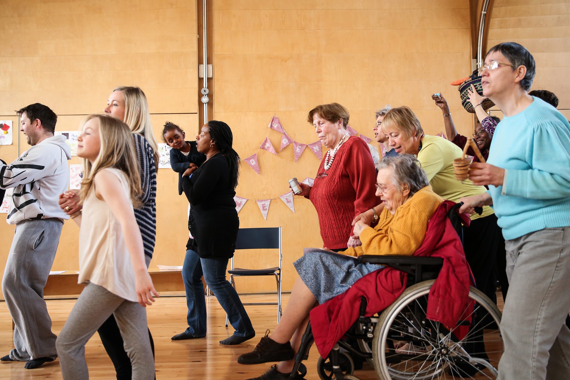 younger and older participants moving in one direction in a hall