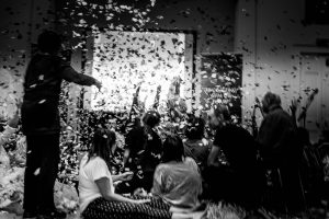 black white image confetti falling over seated participants