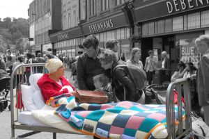 woman in bed in town centre