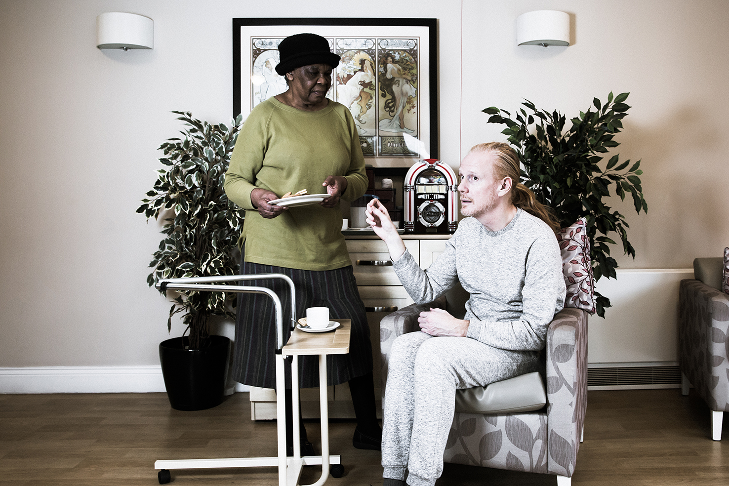 woman standing and man sitting