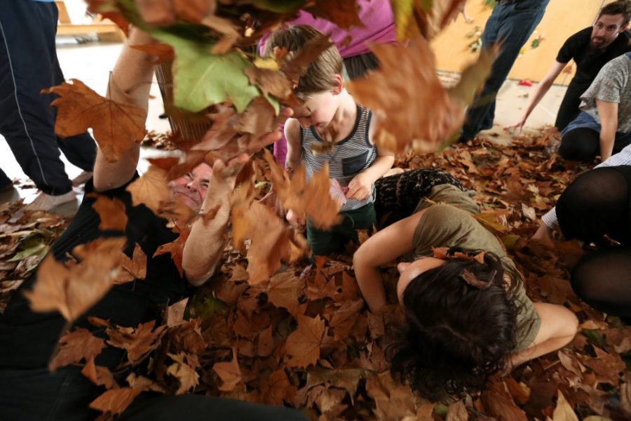 young children playing in dry leaves