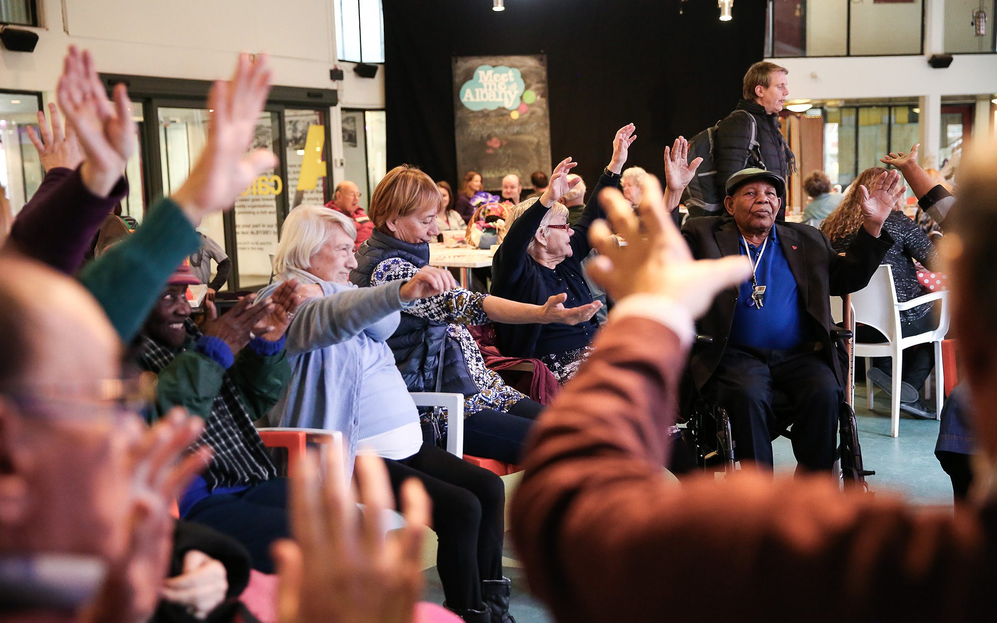 group of Older people waving arms around