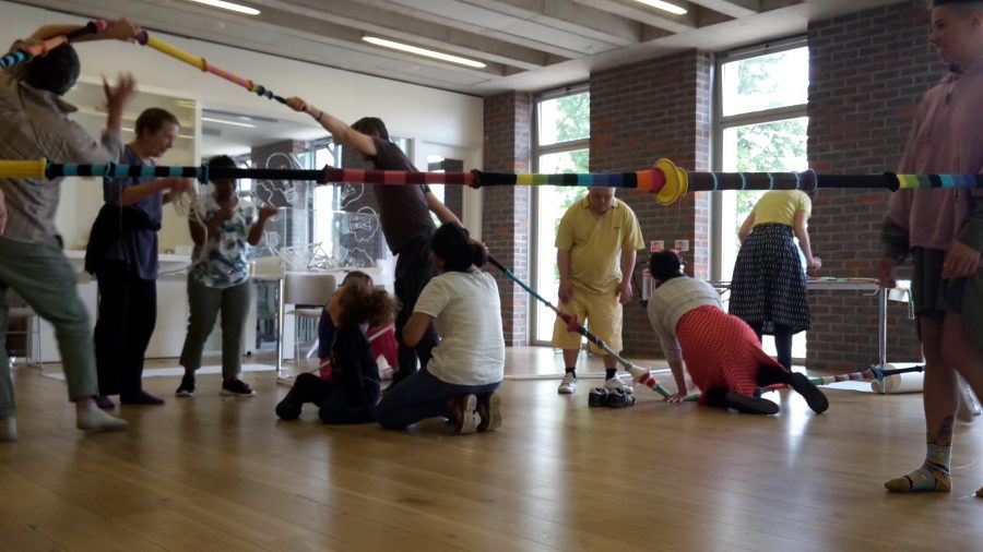 large room with mirror and participants moving