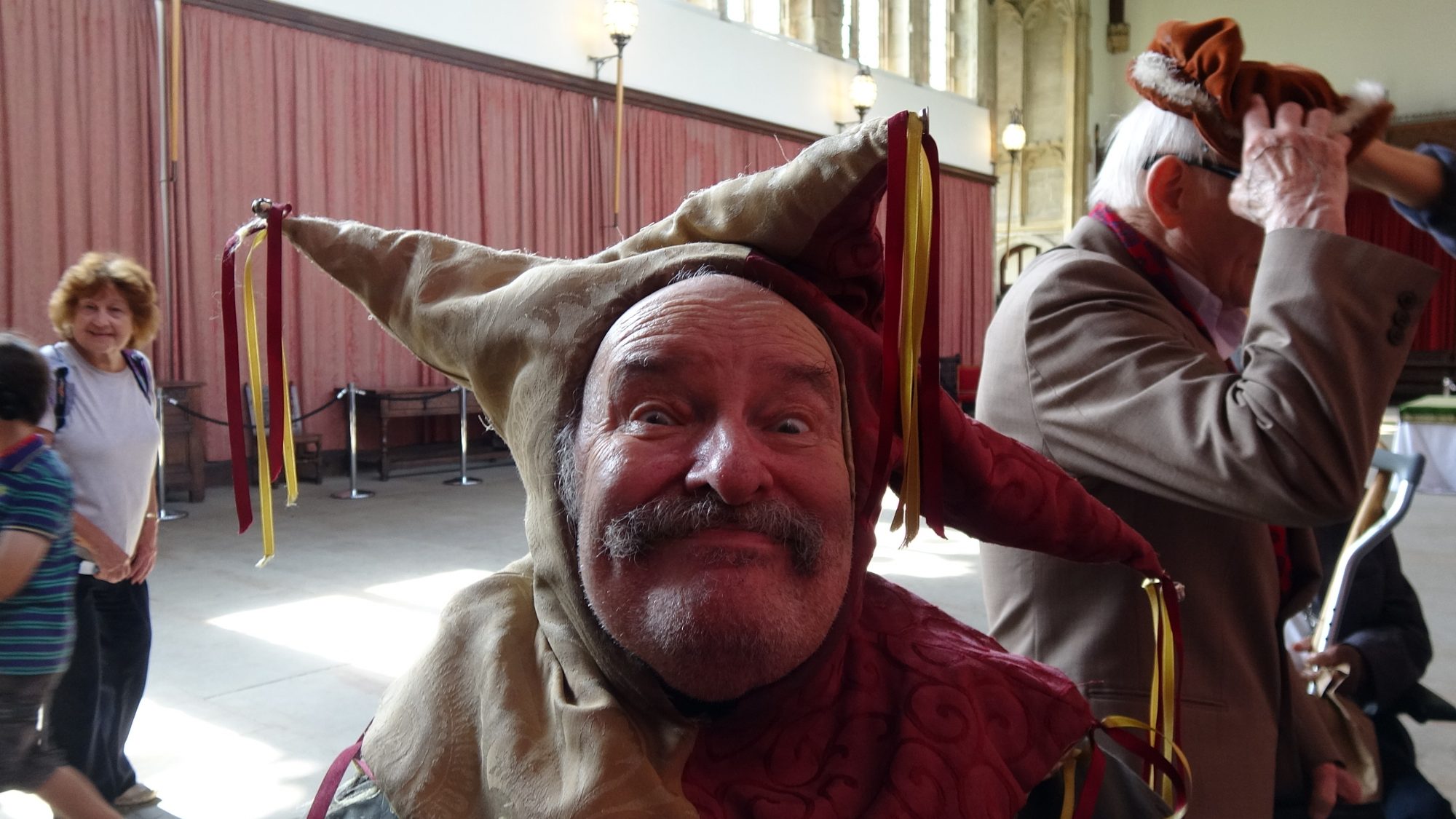 Man in funny hat grinning