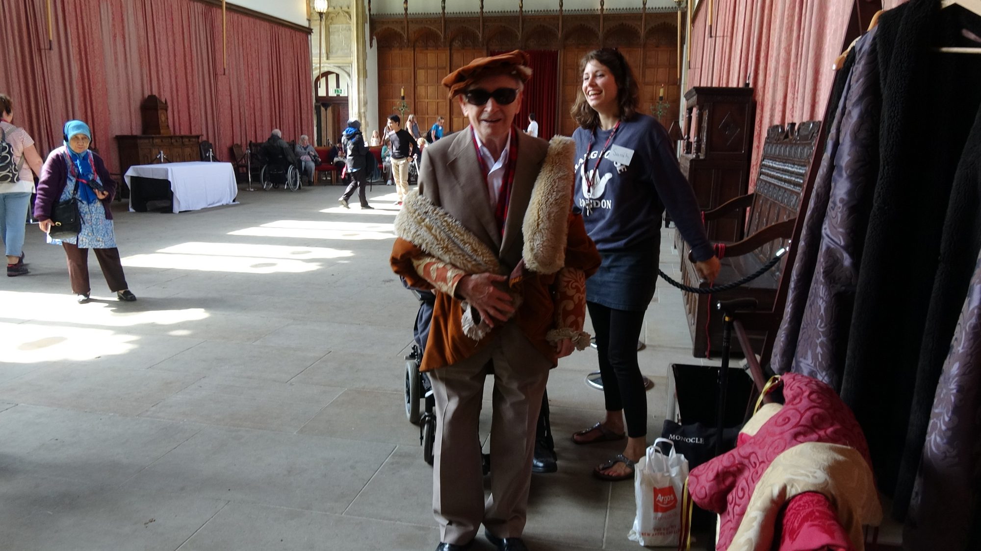 Man dressed up in historical clothing with sunglasses in a big hall