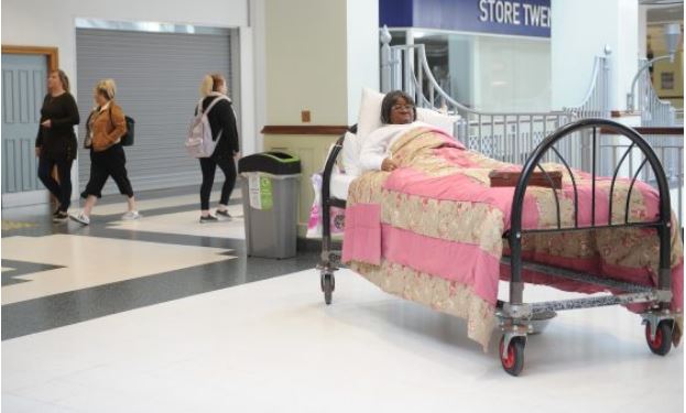 Actor in Bed in shopping centre