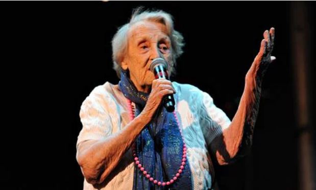 Older woman singing with microphone