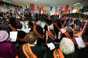 bunting and many people with sashes