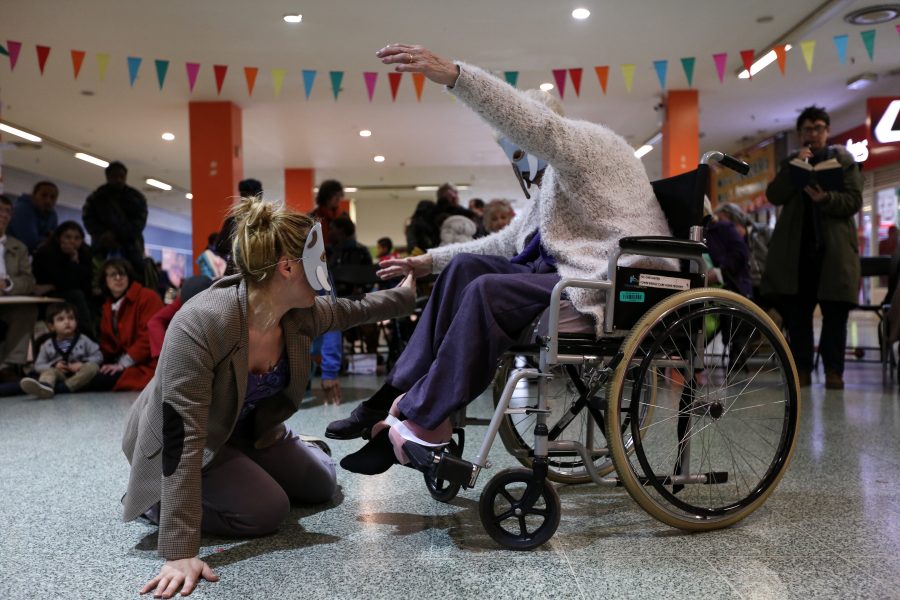 woman in wheelchair with a women in a mask