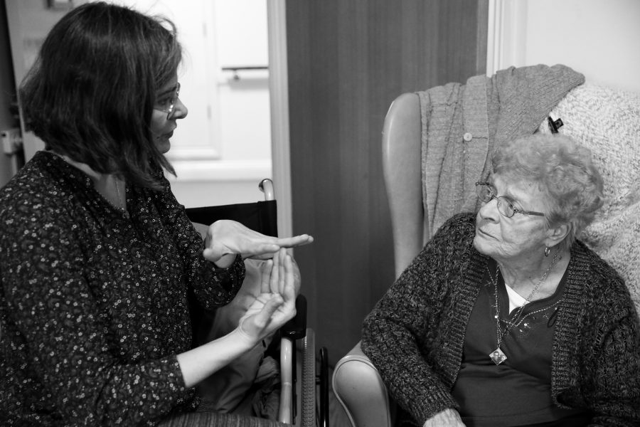 artist talking to older person in care home