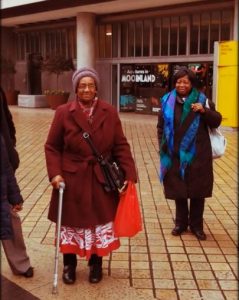 Two women standing in street