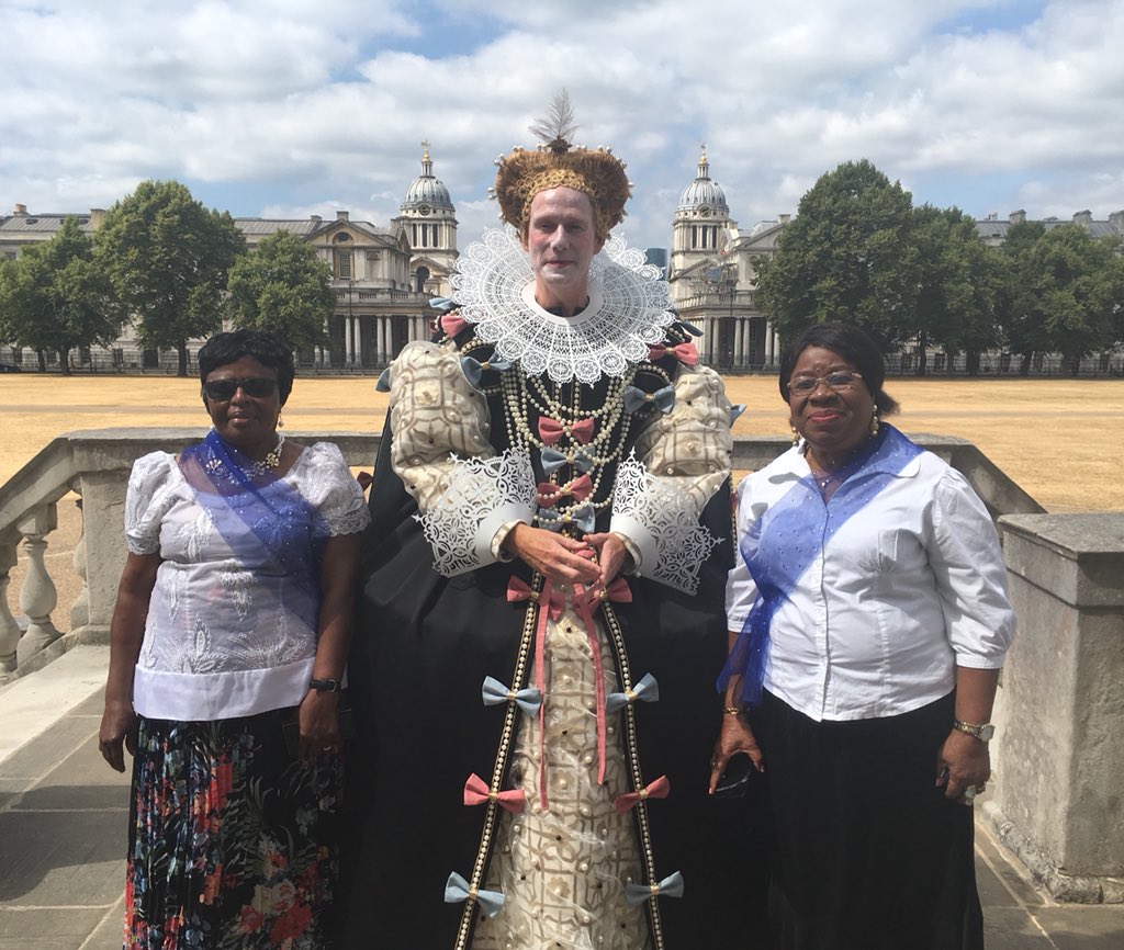 Man dressed as Elizabeth I and 2 women
