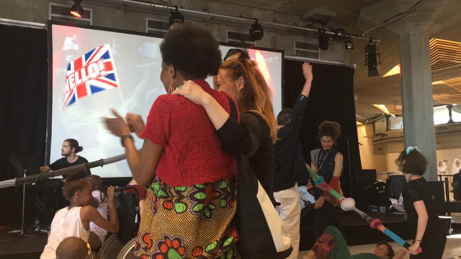 people waving british flag smiling