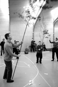 Group in hall holding branches up