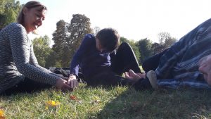 3 people on the grass