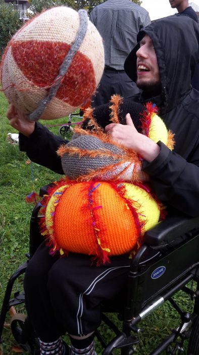 man in wheelchair with coloured balls