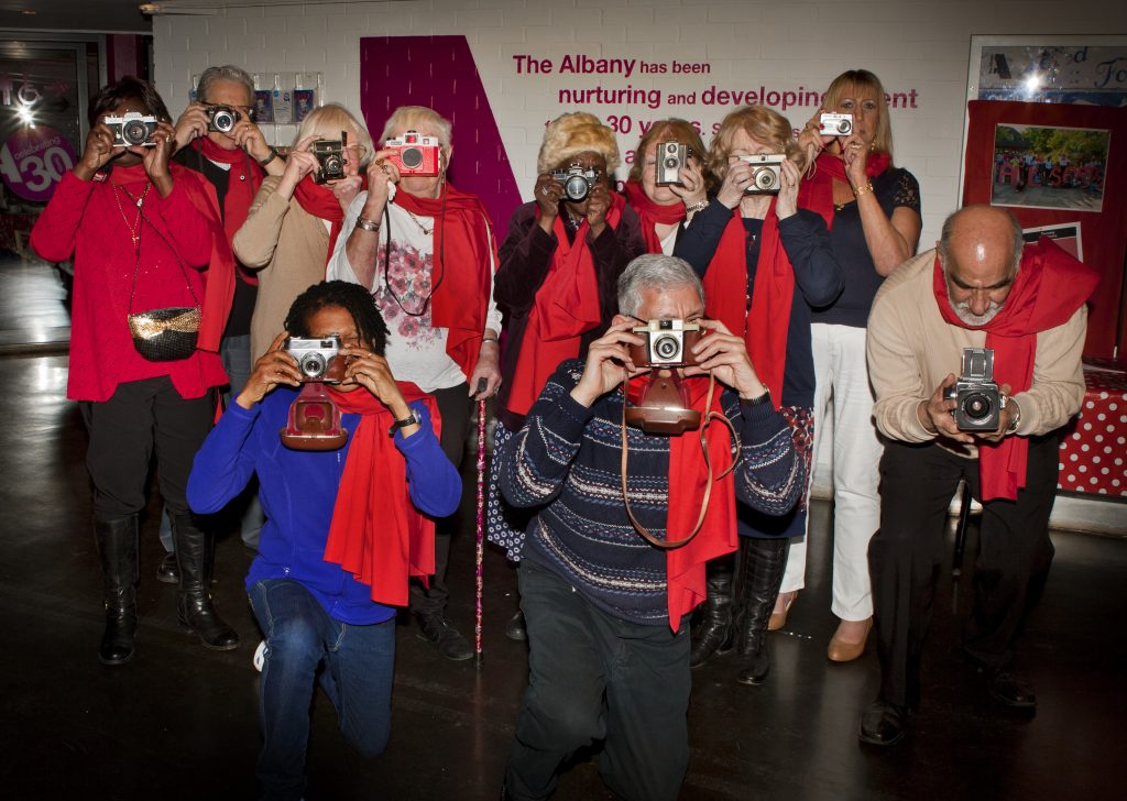 group of people looking at a camera through cameras