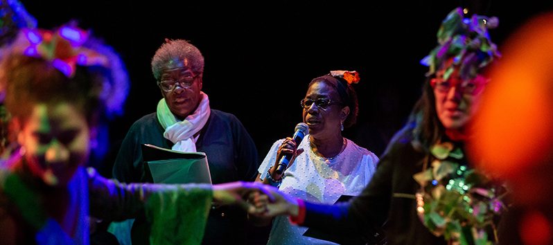 people on a stage talking on a microphone