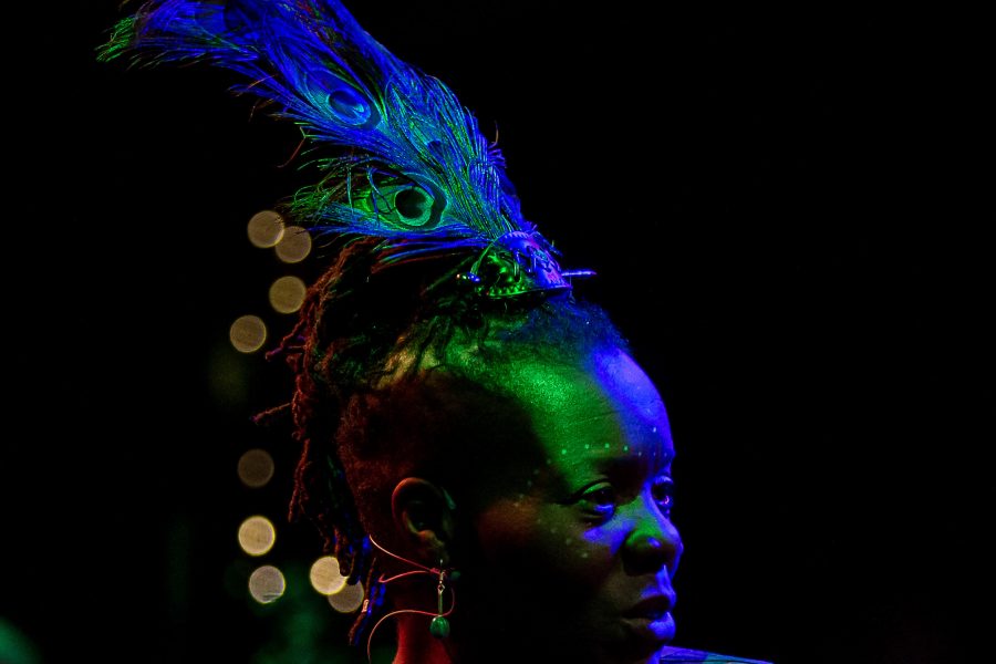 artist with peacock feather headress