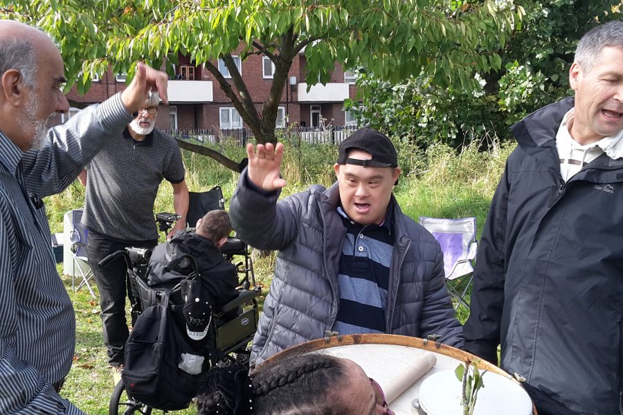 group of people singing amking music in a park