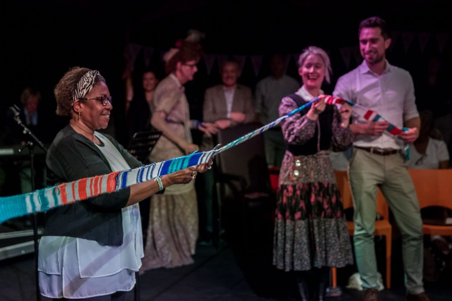 woman cutting a knitted ribbon