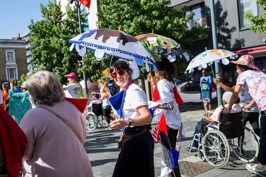 group of people under sun umbrellas