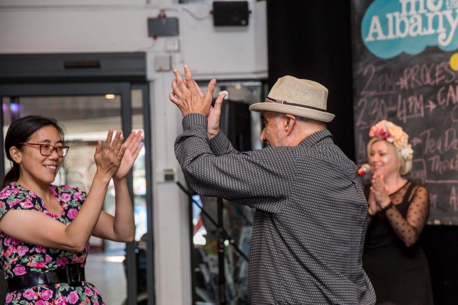 older man dancing and clapping