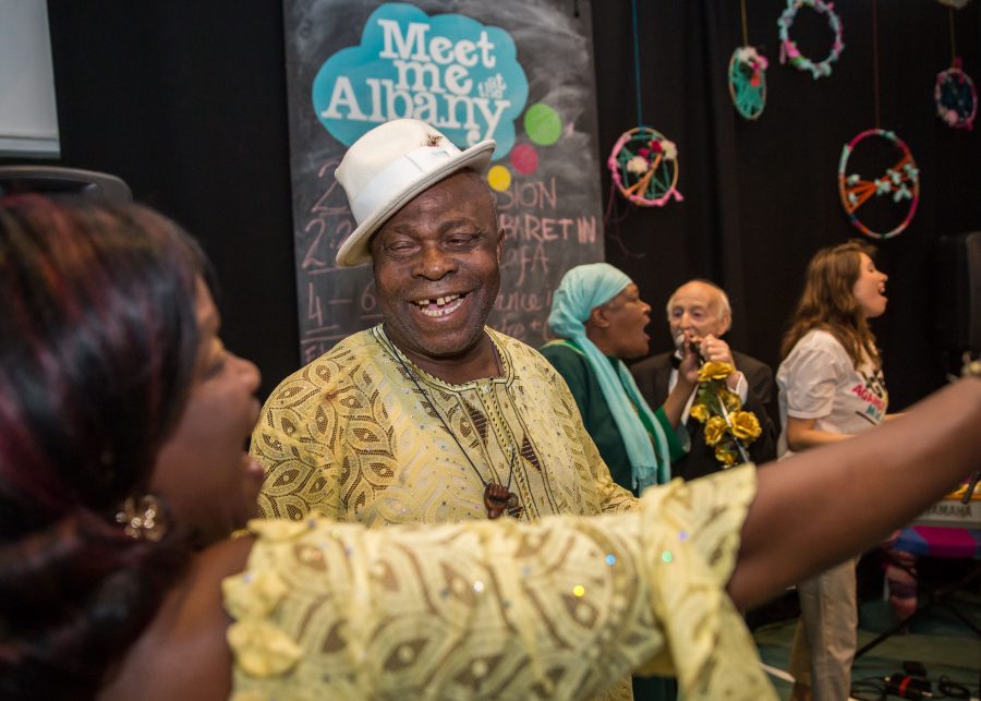 older man smiling with woman dancing