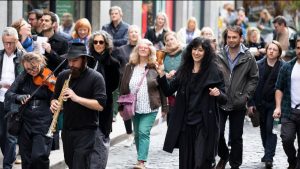 a group of people walking in the street