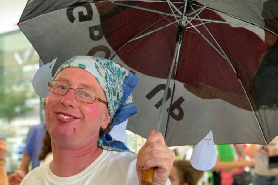 man with umbrella smiling