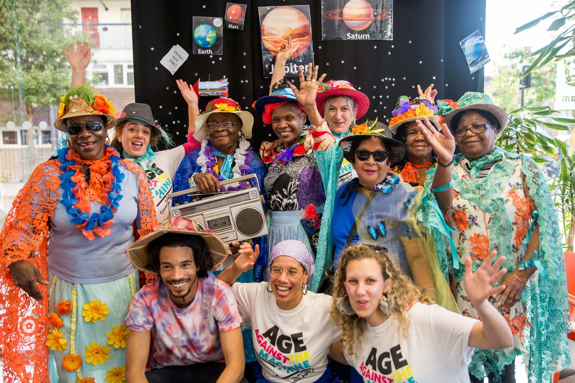 group of performers waving and dressed up in colourful clothes