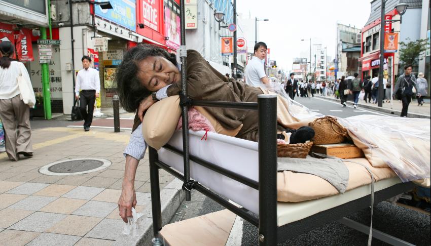 japanese older actor in bed in the street