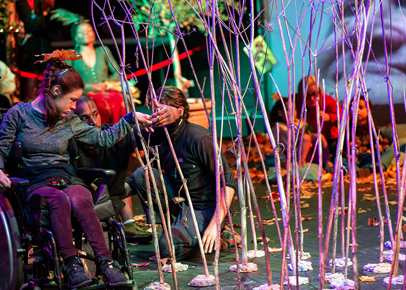 woman and girl in wheelchair talking in theatre set