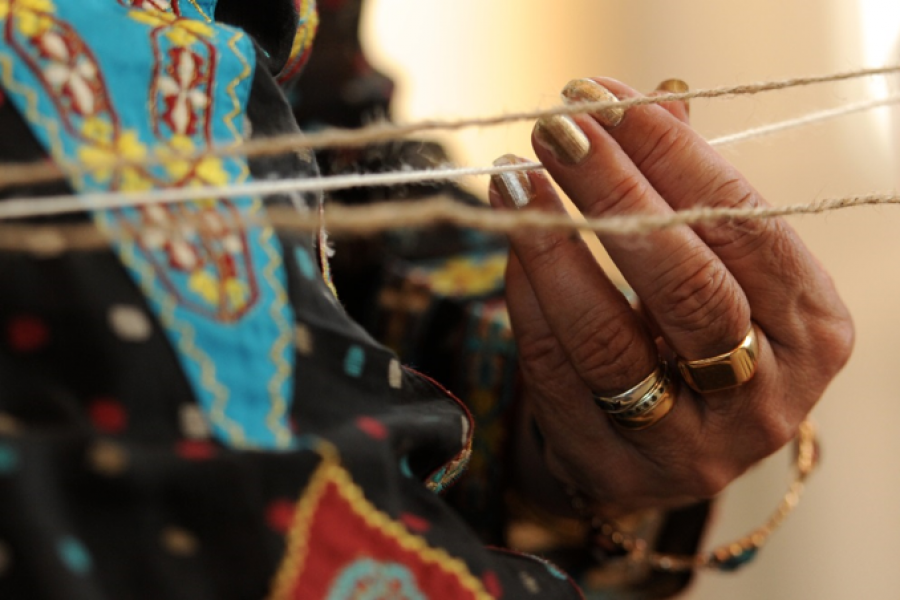 womans hands playing with string