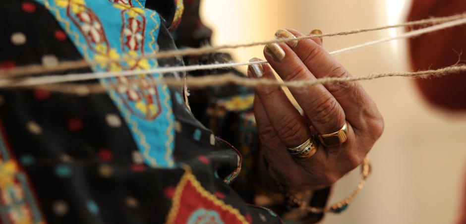 womans hands playing with string