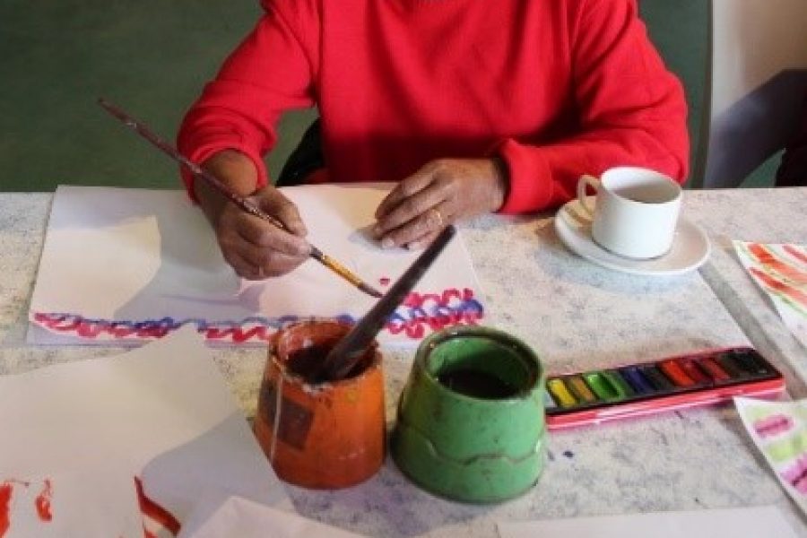 hands of elder person painting