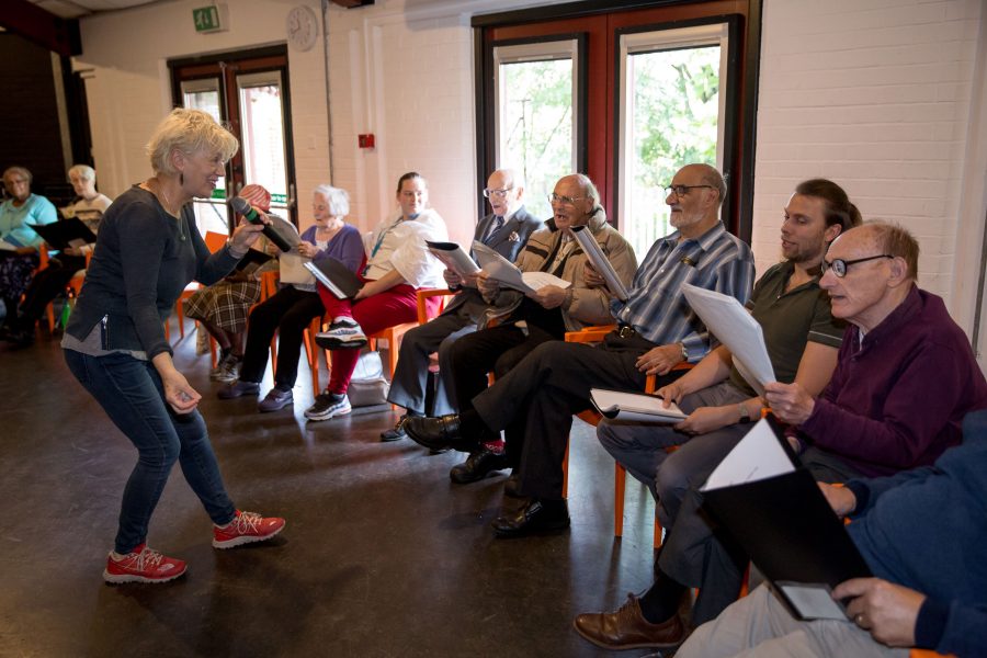 A group of elders in a choir rehearsal