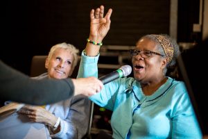 women singing with a microphone