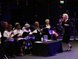 a group of elders singing in a choir at an event