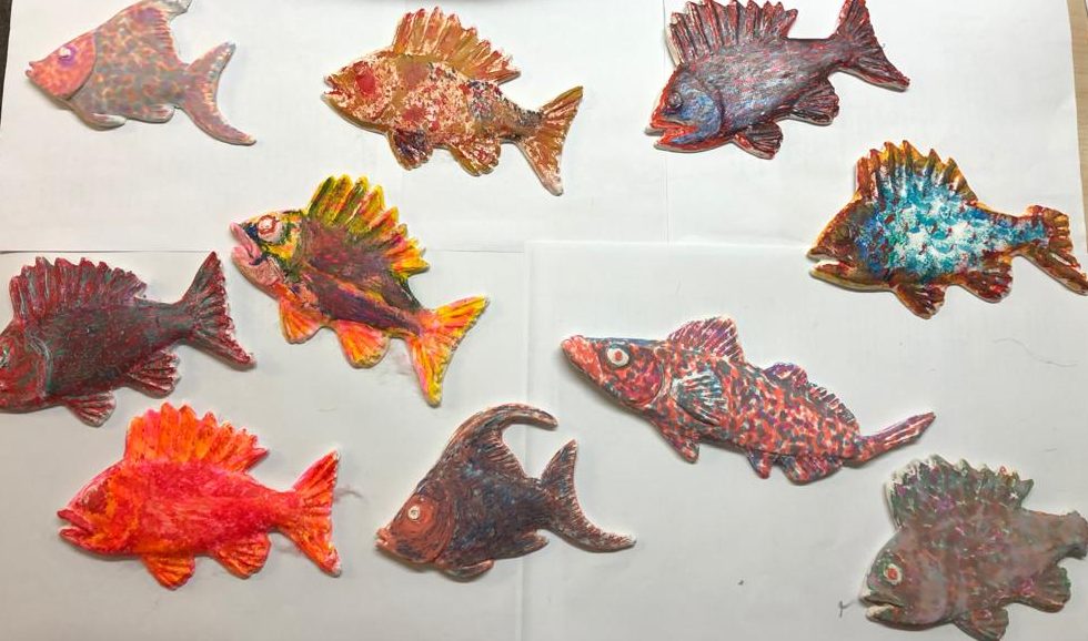 Many painted wooden fish