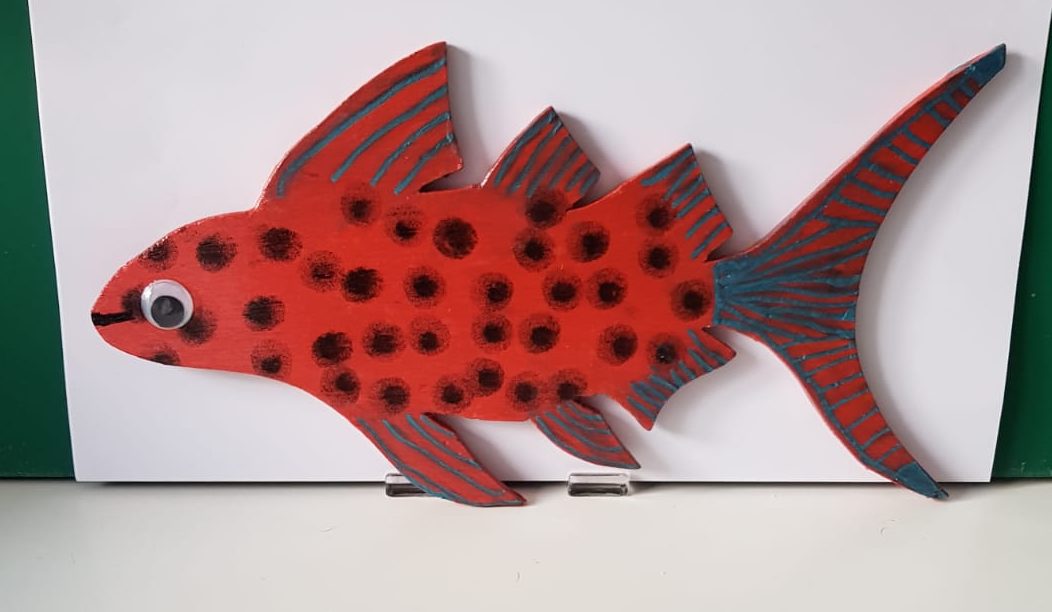 a fish made of wood and painted in bright colours