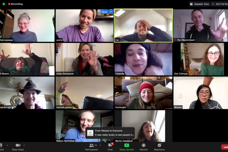 screenshot of a Zoom meeting with images of many people smiling