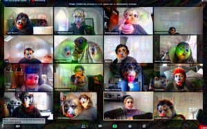 sixteen people on a zoom call. their faces have been changed by the computer to look like colourful animal or alien faces.