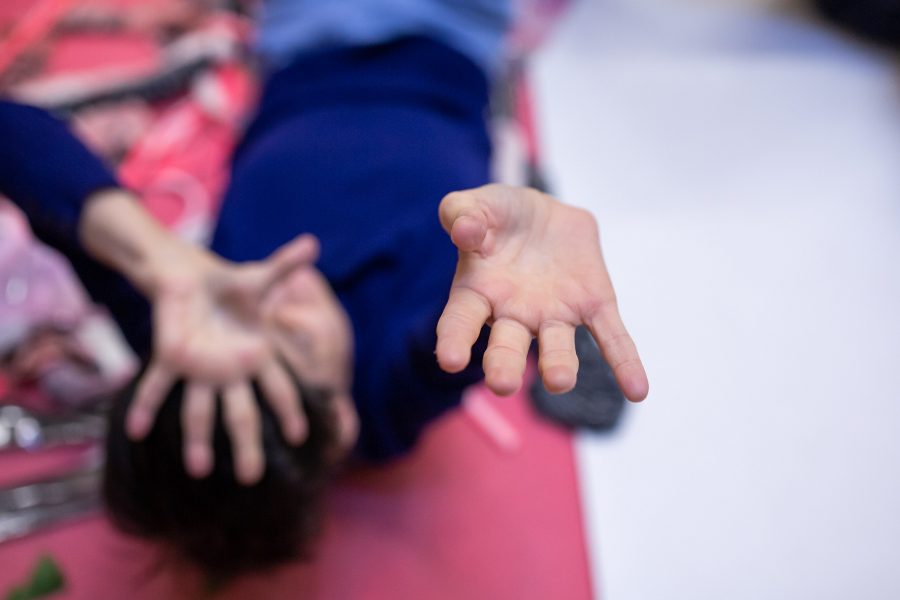 blurry image of a women lying down holding her hand out